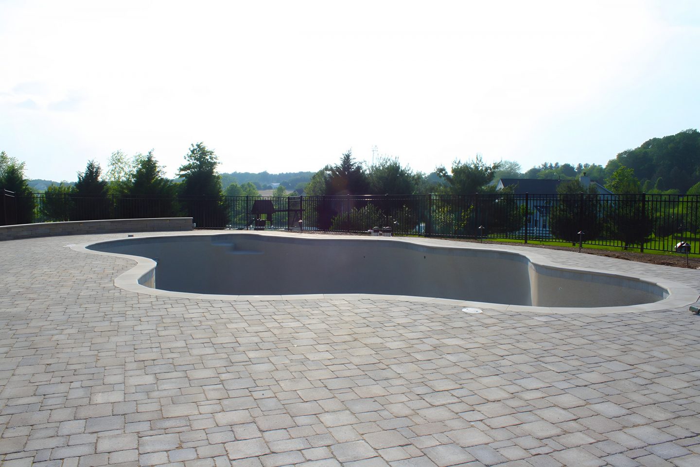 Pool in a residential backyard with an irregular shape