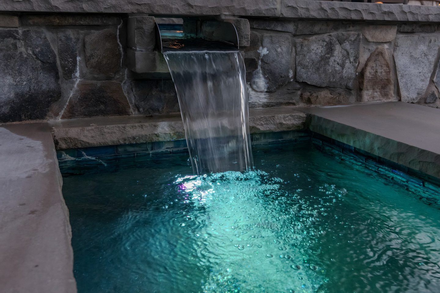 Waterfall flowing into a tiled pool