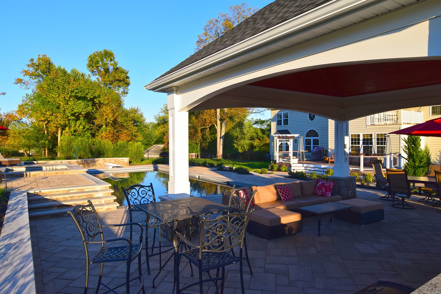 Backyard featuring a patio and pool with a covered seating area